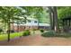 Exterior featuring red brick and white home, green grass, and plenty of foliage at 2179 Mountclaire Ct, Stone Mountain, GA 30087