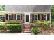 Charming brick home features a classic front entrance with black shutters and well-maintained landscaping at 2179 Mountclaire Ct, Stone Mountain, GA 30087