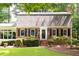 Home featuring a brick exterior, neatly manicured hedges, and dark shutters on each of the windows at 2179 Mountclaire Ct, Stone Mountain, GA 30087