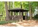 Rustic wooded gazebo with plank siding and diamond details, nestled in trees at 2179 Mountclaire Ct, Stone Mountain, GA 30087