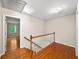 Hallway featuring hardwood floors, railing, and access to other rooms in the home at 2179 Mountclaire Ct, Stone Mountain, GA 30087