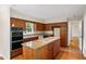 Spacious kitchen featuring a center island, double oven, and wood cabinets at 2179 Mountclaire Ct, Stone Mountain, GA 30087