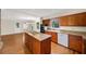 Open kitchen with wood cabinets, an island cooktop, and modern white appliances at 2179 Mountclaire Ct, Stone Mountain, GA 30087