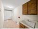 The laundry room includes a utility sink, cabinetry, and extra storage space at 2179 Mountclaire Ct, Stone Mountain, GA 30087