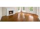 Living room with hardwood floors, a marble fireplace, and sunlit windows providing natural light at 2179 Mountclaire Ct, Stone Mountain, GA 30087