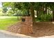 Brick mailbox with black mail slot, topped with a decorative dog figure in a landscaped yard at 2179 Mountclaire Ct, Stone Mountain, GA 30087