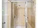Bathroom shower with glass doors, a built-in seat, and a handheld shower head at 2179 Mountclaire Ct, Stone Mountain, GA 30087