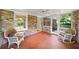 Relaxing sunroom featuring brick walls, mosaic flooring and comfortable wicker seating at 2179 Mountclaire Ct, Stone Mountain, GA 30087