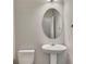 Bathroom featuring a pedestal sink, oval mirror, neutral decor, and tile flooring at 420 Gold Xing, Canton, GA 30114