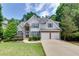 Charming two-story home with well-manicured lawn and a two-car garage at 420 Gold Xing, Canton, GA 30114