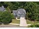 Beautiful two-story home with a well-manicured lawn, lush trees, and a two-car garage at 420 Gold Xing, Canton, GA 30114