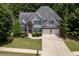 Charming two-story home with a two-car garage, landscaped yard, and stone accents at 420 Gold Xing, Canton, GA 30114