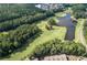 Scenic aerial of a lush golf course with a tranquil pond, surrounded by mature trees and manicured greens at 420 Gold Xing, Canton, GA 30114