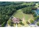 Aerial showcases a lush golf course with well-maintained greens and scenic views, surrounded by trees at 420 Gold Xing, Canton, GA 30114