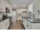 Well-appointed kitchen with stainless steel appliances, granite countertops, and white cabinetry for ample storage at 420 Gold Xing, Canton, GA 30114
