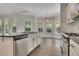 Inviting kitchen featuring a bay window, gas range, stainless steel dishwasher, and modern finishes at 420 Gold Xing, Canton, GA 30114