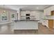 Eat-in kitchen features a central island, white cabinetry, granite countertops, and stainless steel appliances at 420 Gold Xing, Canton, GA 30114
