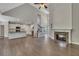 Bright, open-concept living room showcasing hardwood floors, a stone fireplace, and seamless kitchen access at 420 Gold Xing, Canton, GA 30114
