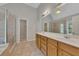 Bright main bathroom with double vanity sinks, large mirror, tile flooring and glass-enclosed shower at 420 Gold Xing, Canton, GA 30114
