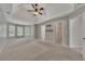 Spacious main bedroom featuring a tray ceiling, ceiling fan, and lots of natural light from the windows at 420 Gold Xing, Canton, GA 30114