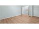 A bedroom with light blue walls and wood floors with a large walk-in closet at 4211 Burnt Hickory Nw Rd, Marietta, GA 30064