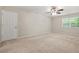 Carpeted bedroom with a ceiling fan and a bright window at 4211 Burnt Hickory Nw Rd, Marietta, GA 30064