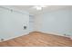 A bedroom with light blue walls, wood floors with shelves and a door at 4211 Burnt Hickory Nw Rd, Marietta, GA 30064