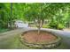 Spacious driveway and lush landscaping leading to a charming two-story home at 4211 Burnt Hickory Nw Rd, Marietta, GA 30064