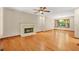 Sunlit living room featuring hardwood floors, a fireplace, and large windows at 4211 Burnt Hickory Nw Rd, Marietta, GA 30064