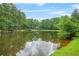 Scenic pond surrounded by lush greenery provides a serene backdrop at 4211 Burnt Hickory Nw Rd, Marietta, GA 30064