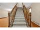 Carpeted stairway with wood railing leading to the upper level at 4211 Burnt Hickory Nw Rd, Marietta, GA 30064