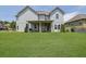 Large grassy backyard with a covered patio and a view of the home's exterior at 4315 Balsam Bark Dr, Cumming, GA 30028