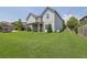Large grassy backyard with covered patio and exterior of a two-story home at 4315 Balsam Bark Dr, Cumming, GA 30028