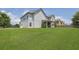 Spacious grassy backyard with a covered patio and view of a two-story home at 4315 Balsam Bark Dr, Cumming, GA 30028