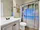 Bright bathroom features a toilet and a vanity with a beach-themed shower curtain at 4315 Balsam Bark Dr, Cumming, GA 30028