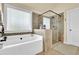Serene bathroom offers a soaking tub, separate glass shower, and modern fixtures for a luxurious bathing experience at 4315 Balsam Bark Dr, Cumming, GA 30028