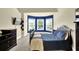 Bedroom with a queen bed in front of bay windows, dark furniture, and carpet at 4315 Balsam Bark Dr, Cumming, GA 30028