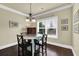Cozy dining room with wood floors, natural light, and a modern chandelier at 4315 Balsam Bark Dr, Cumming, GA 30028