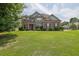 Charming brick two-story home with a well-manicured lawn and a welcoming front entrance at 4315 Balsam Bark Dr, Cumming, GA 30028