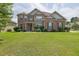 Charming brick two-story home with a well-manicured lawn and a welcoming front entrance at 4315 Balsam Bark Dr, Cumming, GA 30028