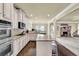 Bright kitchen features stainless appliances, granite counters, wood floors and an archway to the living room at 4315 Balsam Bark Dr, Cumming, GA 30028