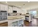 Kitchen featuring stainless appliances, granite counters, a central island with seating and wood floors at 4315 Balsam Bark Dr, Cumming, GA 30028