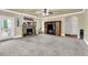 Spacious living room features a stone fireplace, plush carpet, and convenient patio access at 4315 Balsam Bark Dr, Cumming, GA 30028
