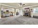 Open-concept living room with a stone fireplace, staircase, and an archway to the kitchen and dining area at 4315 Balsam Bark Dr, Cumming, GA 30028