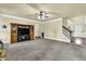 Open living room featuring neutral walls, a ceiling fan, and stairs leading to a second level at 4315 Balsam Bark Dr, Cumming, GA 30028
