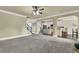Open living room showcasing neutral walls, a ceiling fan, and an archway to the kitchen at 4315 Balsam Bark Dr, Cumming, GA 30028