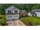 An aerial view showcases this two-story home and its well-maintained lawn, shrubs and mature trees at 5485 Shirewick Ln, Lithonia, GA 30058