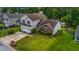 Aerial view of a well maintained two-story home on a lush lot with an attached two car garage at 5485 Shirewick Ln, Lithonia, GA 30058