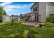 Cozy backyard featuring a patio for outdoor seating, lush green grass, and privacy trees at 5485 Shirewick Ln, Lithonia, GA 30058