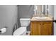 Cozy bathroom featuring a wood vanity and toilet with neutral walls, for a clean and functional space at 5485 Shirewick Ln, Lithonia, GA 30058